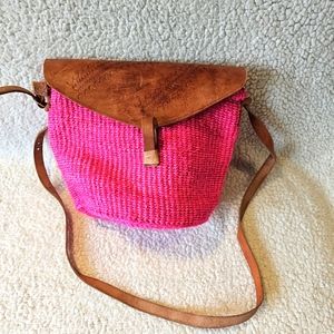 Hot pink woven bucket bag with leather strap and closure